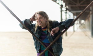 A photograph of performance artist Tom Marshman standing under the pier on Weston Super Mare beach