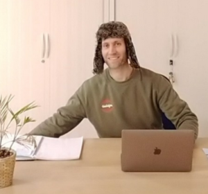 Profile picture of a man wearing a hat in an office setting